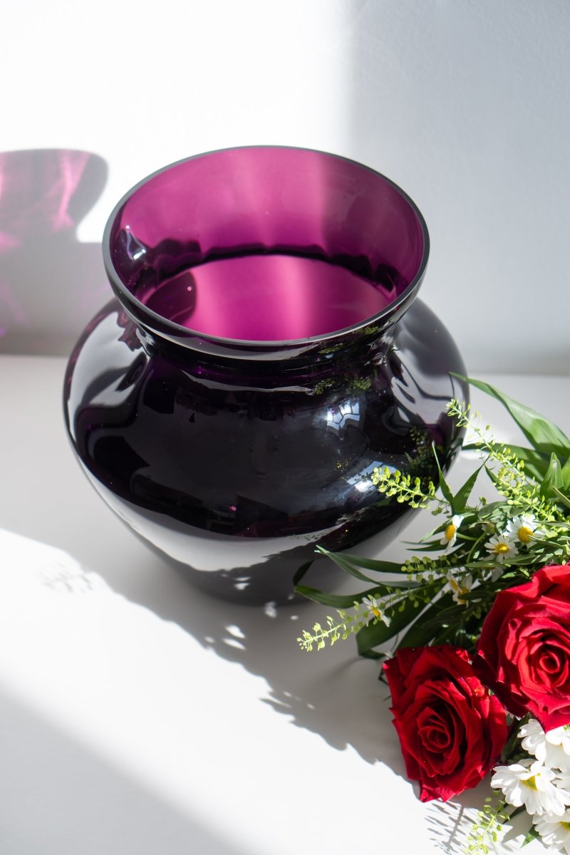 Violet Marika Vase Large on a white piece of furniture with a bouquet of flowers and a white background