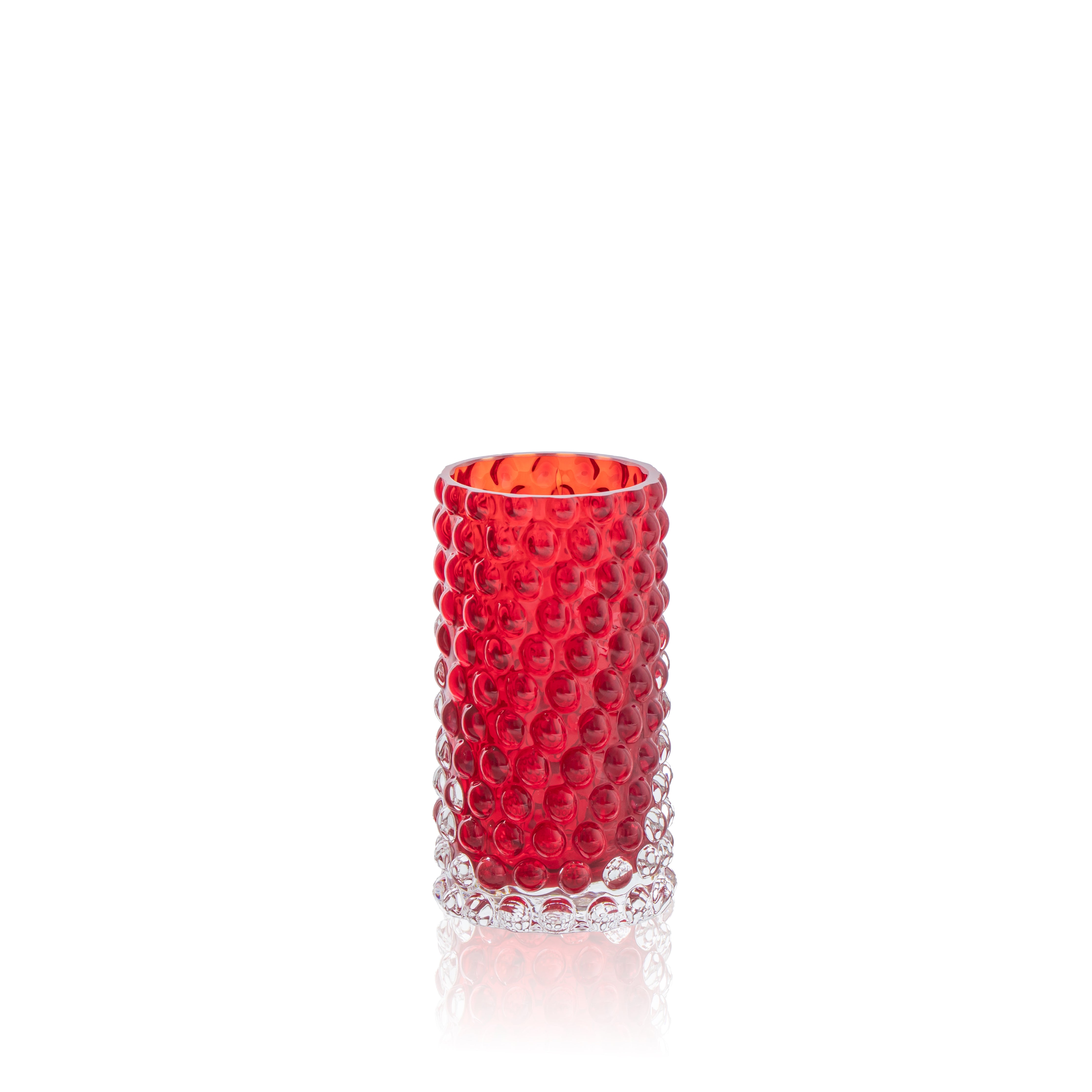 Red textured glass vase on a white background