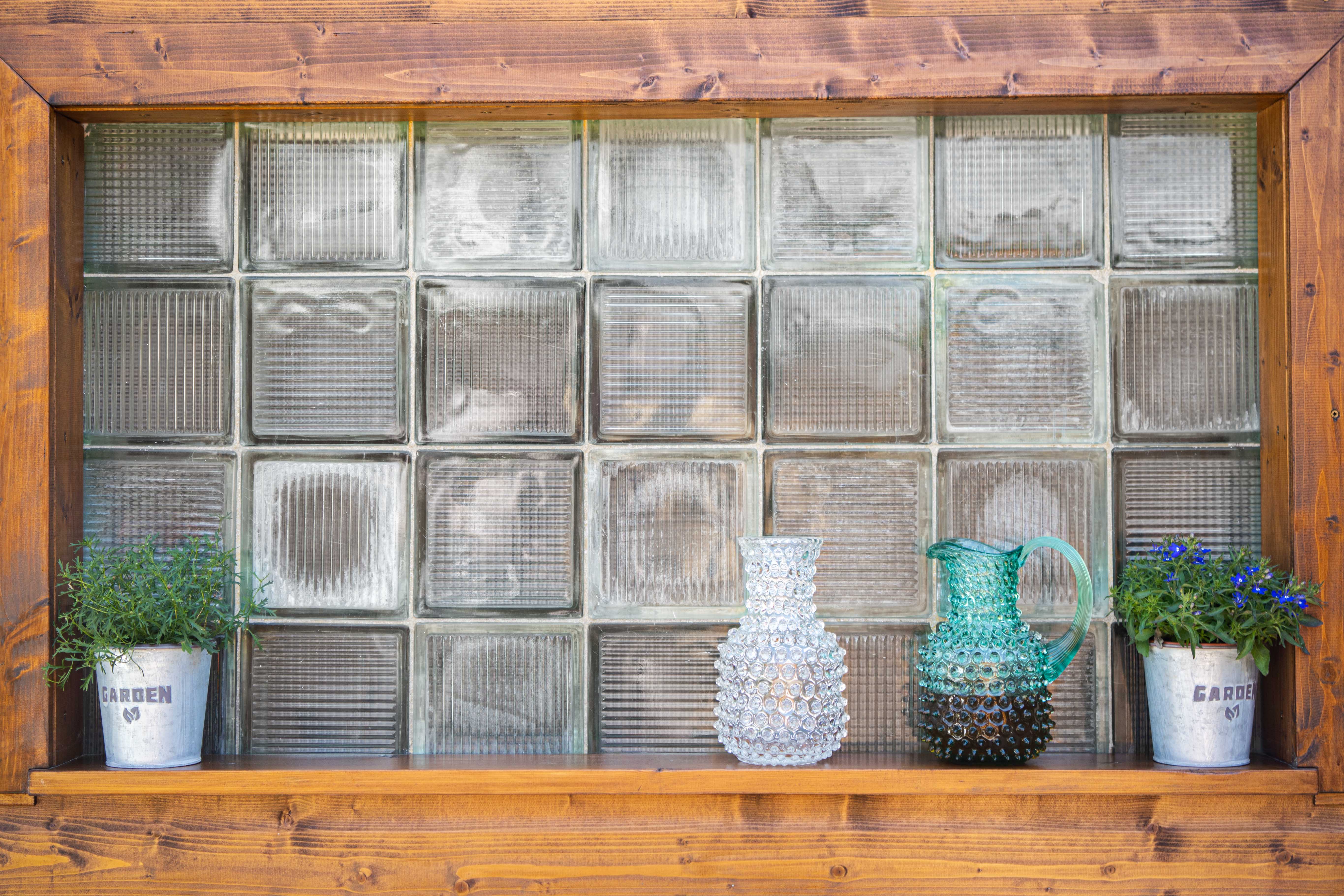 Crystal Hobnail Carafe and Beryl Glass Square Jug standing on the window