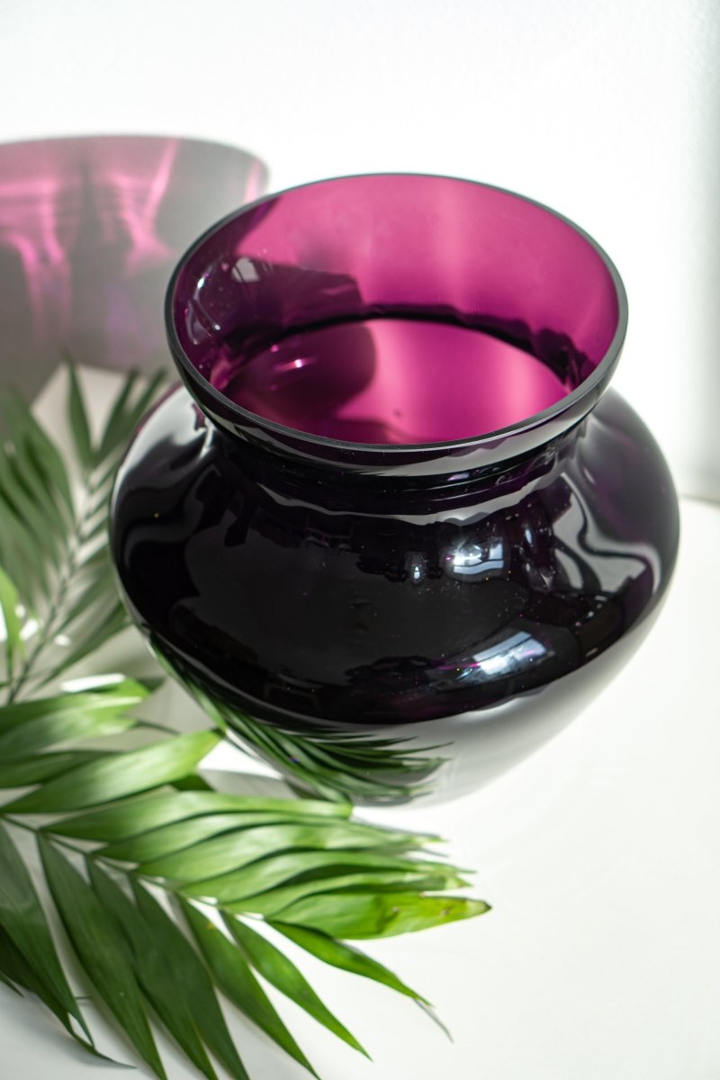 Violet Marika Vase Large on a white piece of furniture with plants and a white background 